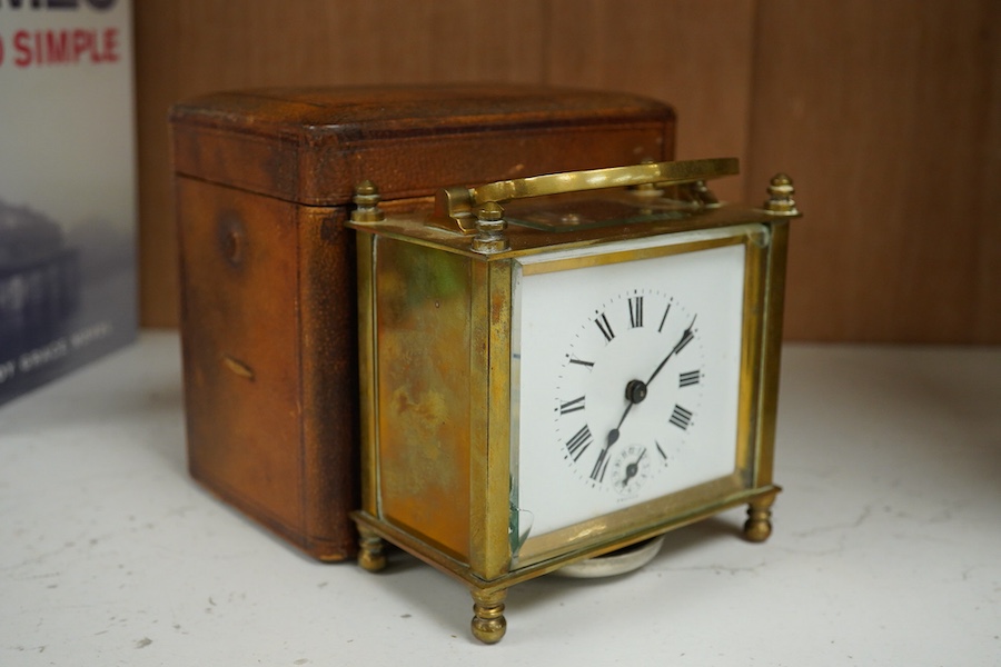 A cased French brass carriage timepiece with alarm, 12cm high